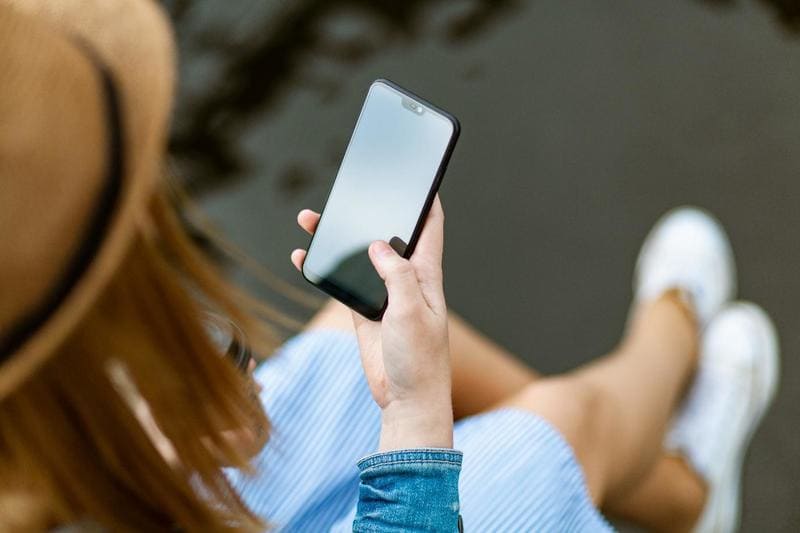 Person Testing a New Mobile App on Her Phone